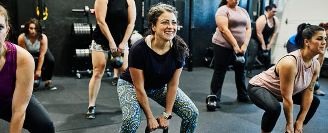 Eine Gruppe Frauen im Fitnessstudio trainieren mit Kettleballs